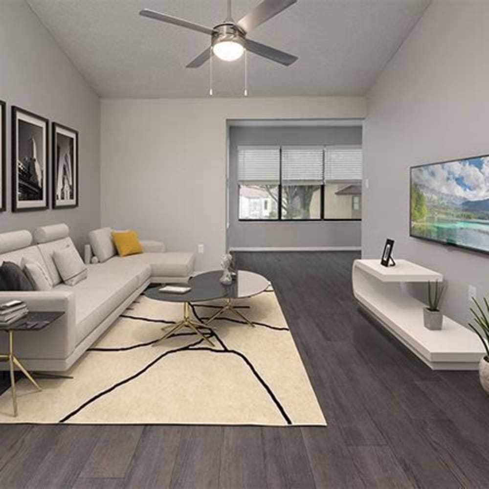 Living space with a ceiling fan and wood-style flooring at The Edge at Lake Lotus in Altamonte Springs, Florida