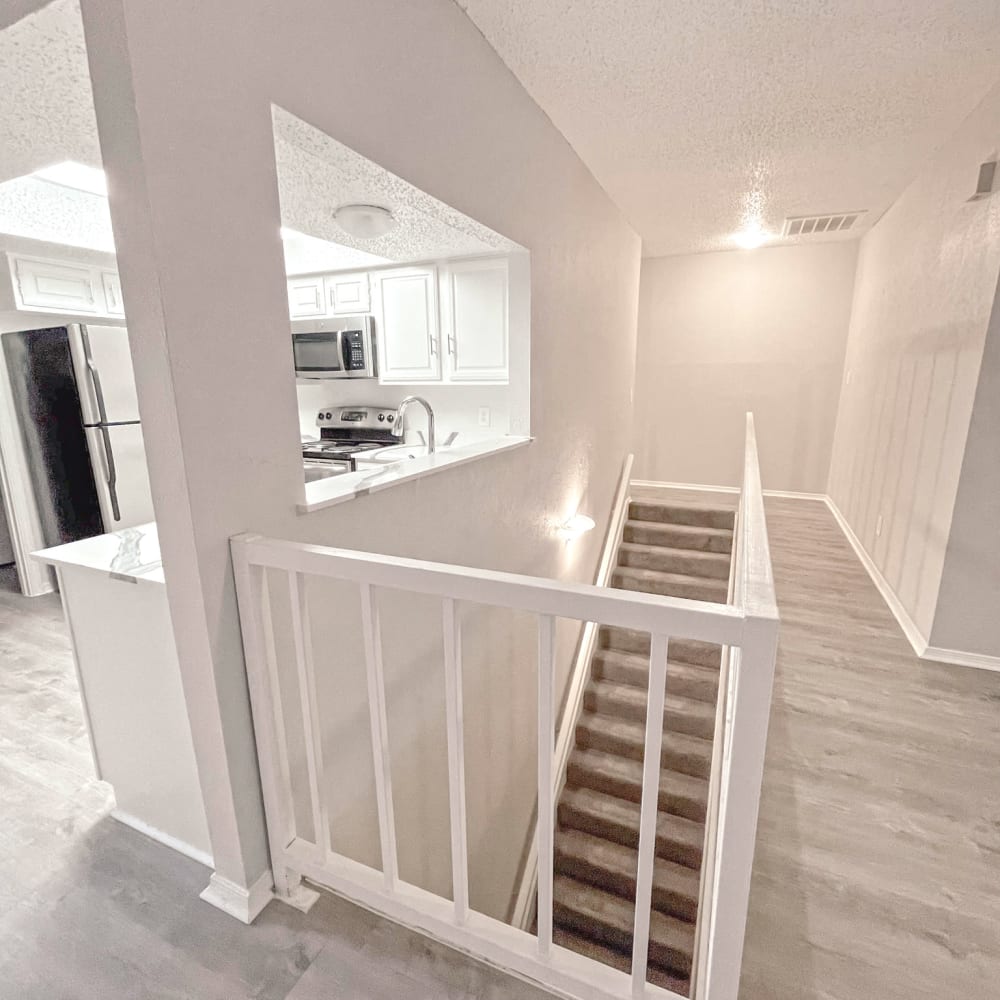 Open kitchen and living area with stairs to bottom floor at Oaks White Rock. 