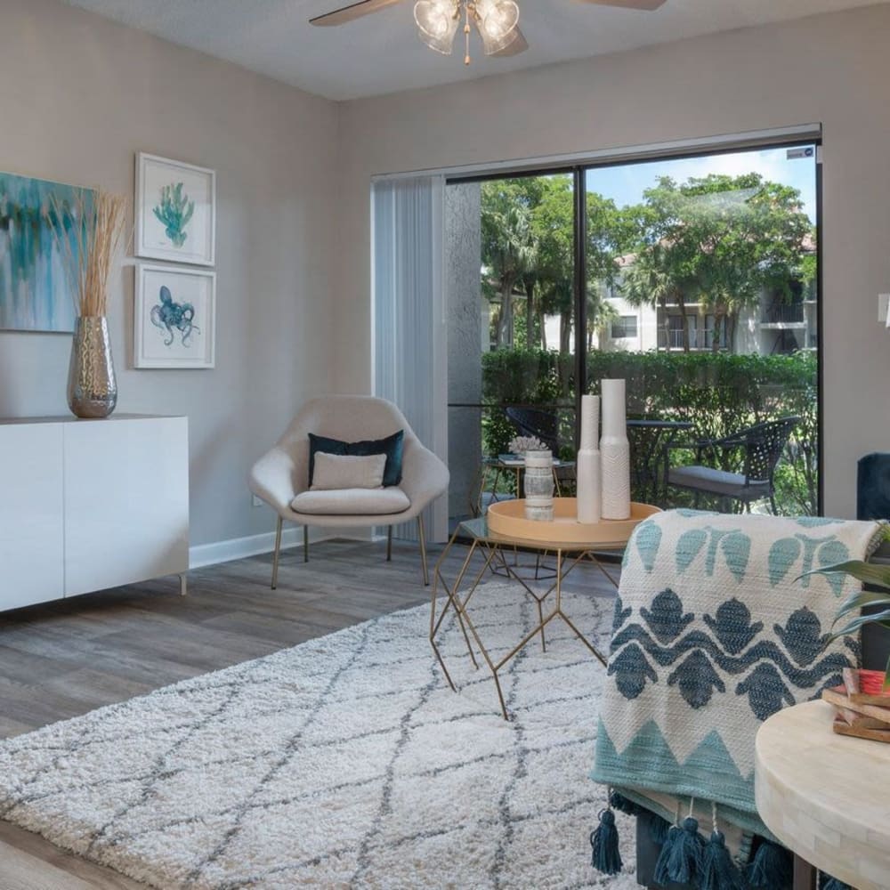 Living space with wood-style flooring at Ashley Lake Park Apartments in Boynton Beach, Florida
