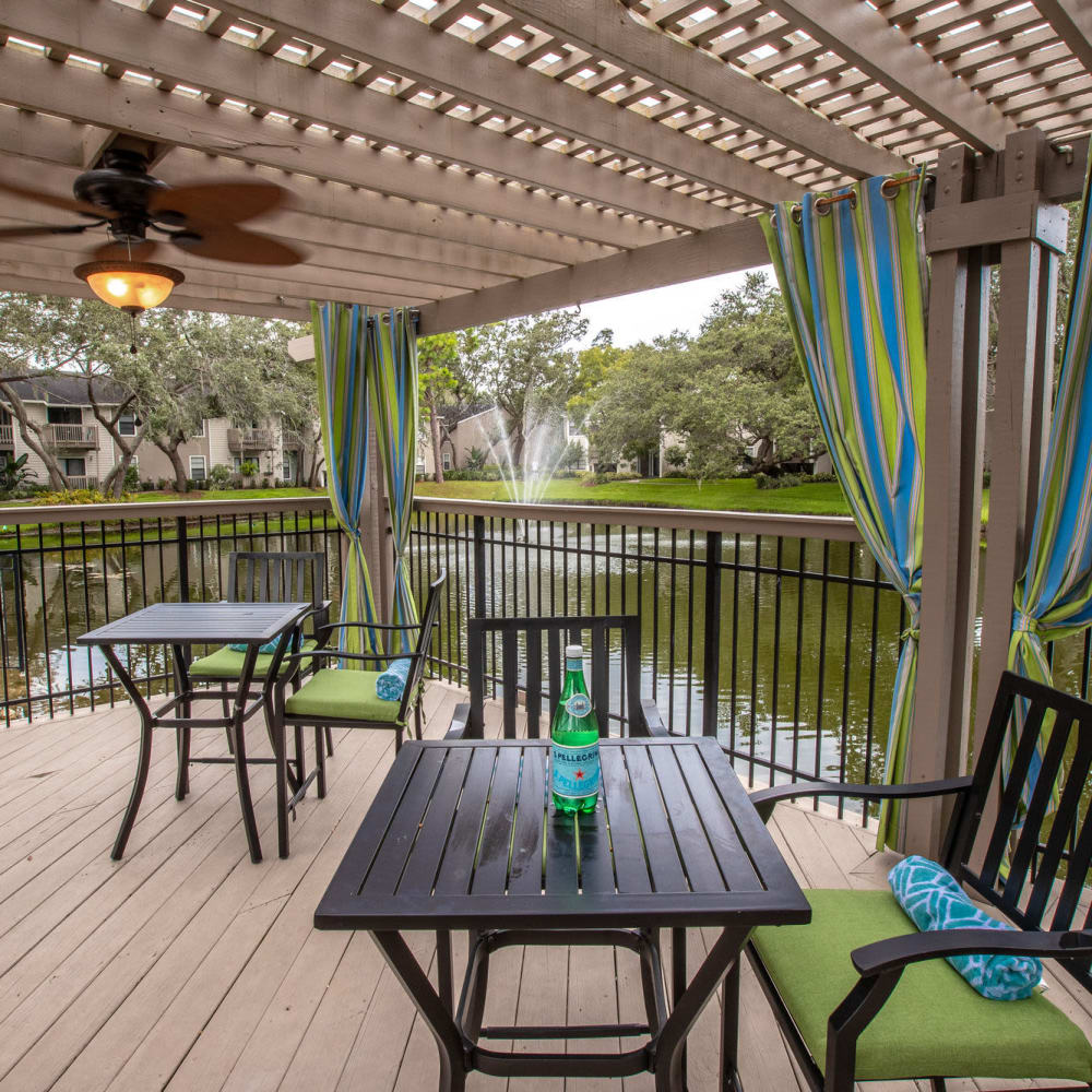 Pond side patio with tables and chairs at Stillwater Palms in Palm Harbor, Florida