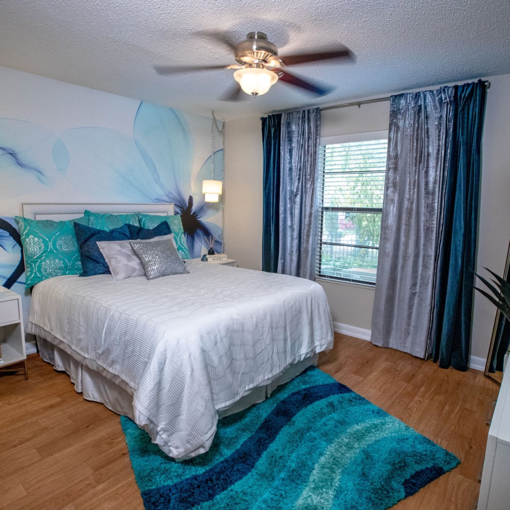 Master bedroom with wood-style flooring at Stillwater Palms in Palm Harbor, Florida