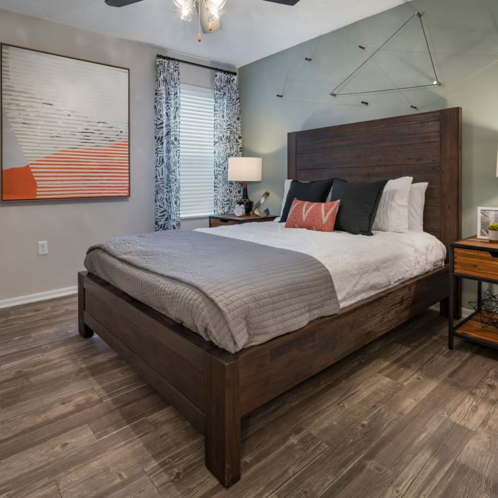 Master bedroom with wood-style flooring at Solis At Winter Park in Winter Park, Florida