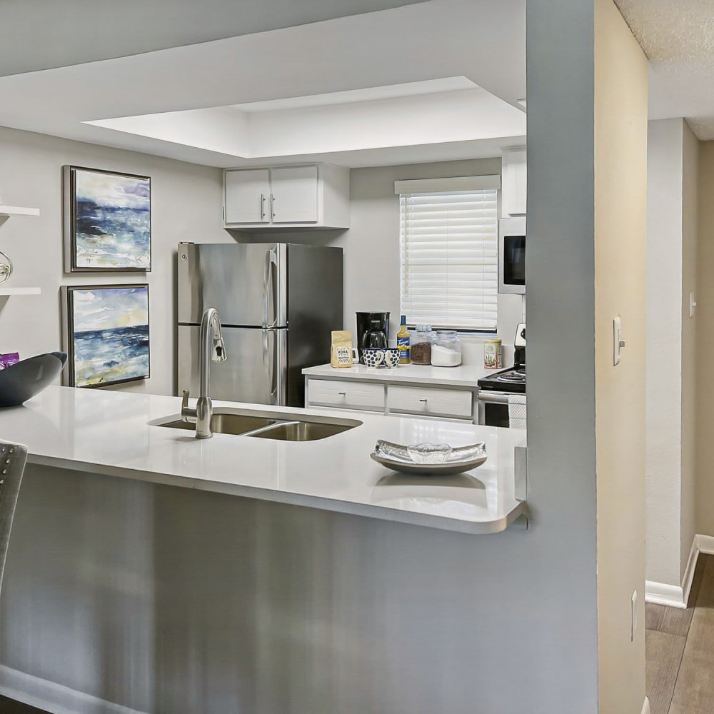 Kitchen with a breakfast bar at WestEnd Apartments in Tampa, Florida