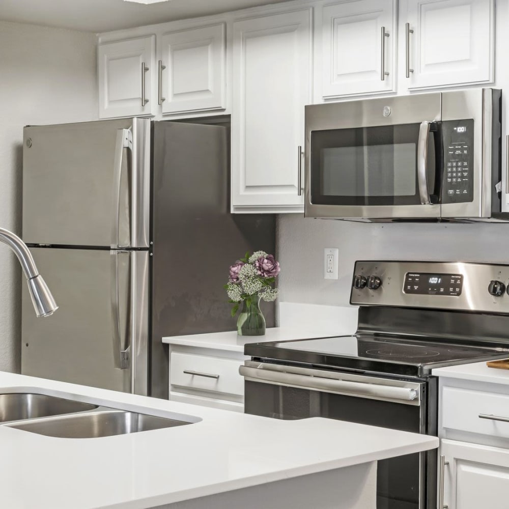 Modern kitchen with stainless-steel appliances at Bayou Point in Pinellas Park, Florida