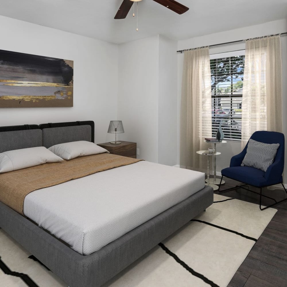 Master bedroom with a ceiling fan at Bayou Point in Pinellas Park, Florida