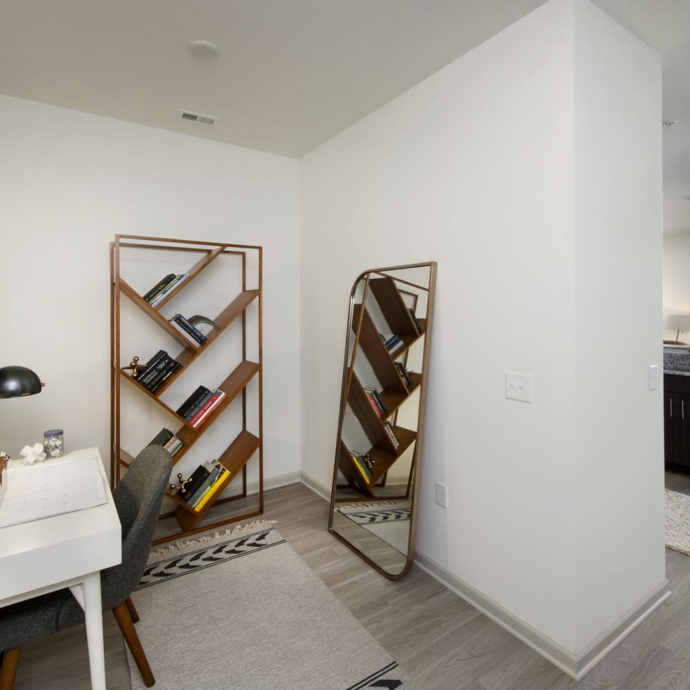 Extra cove space with a table and wine racks at Alcove Apartments in Orlando, Florida