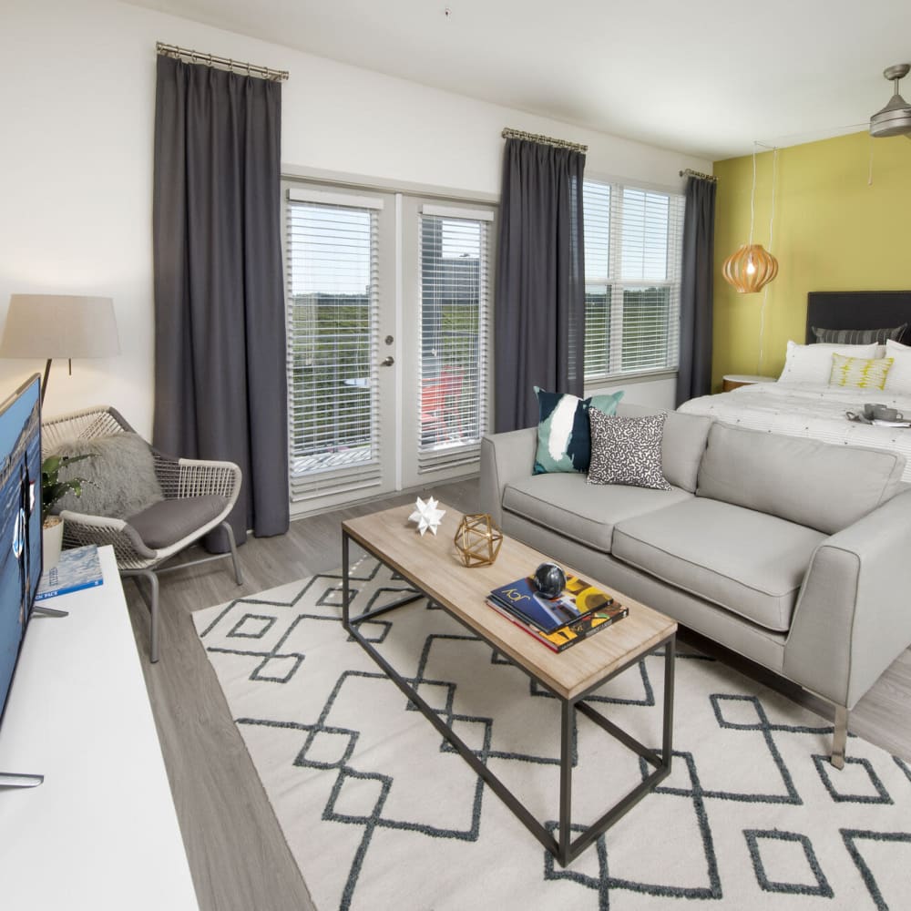 Studio living space with ample natural light at Alcove Apartments in Orlando, Florida