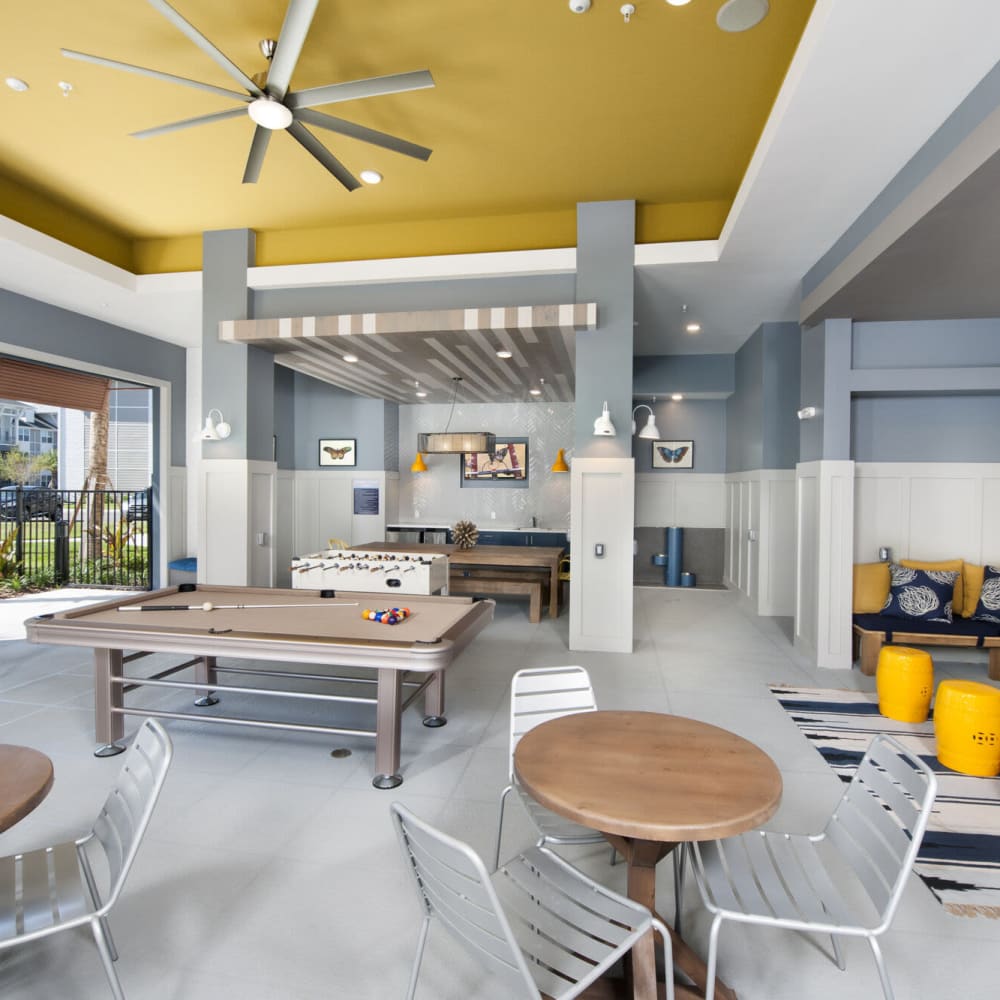 Indoor entertainment gathering space at Alcove Apartments in Orlando, Florida