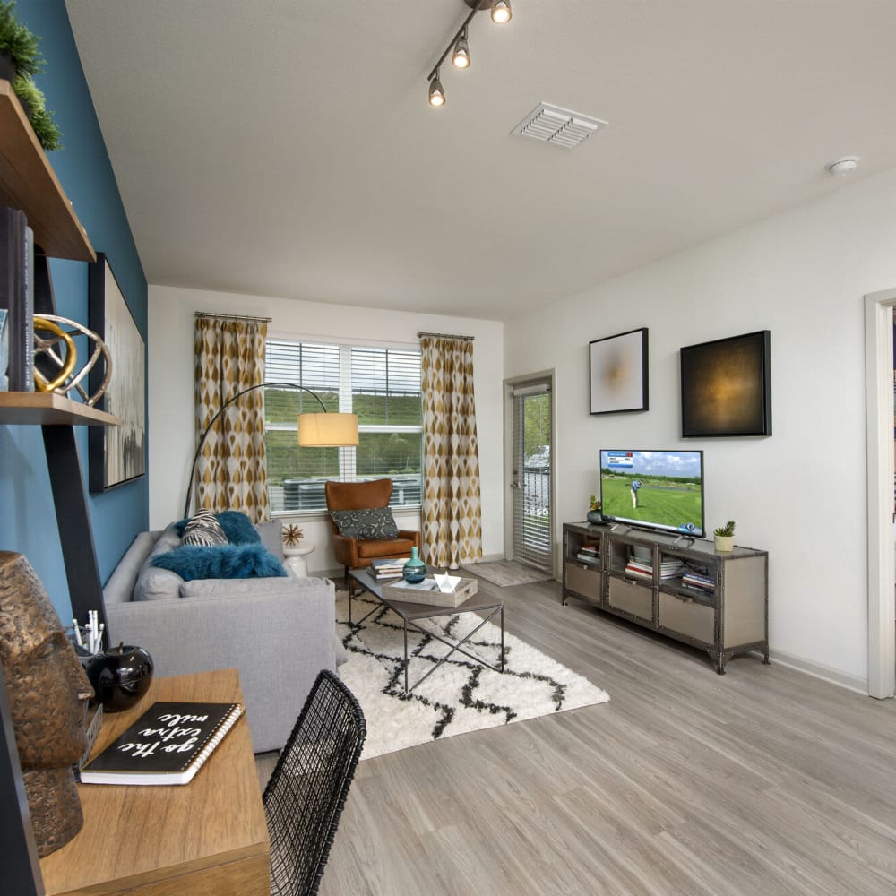 Living space with wood-style flooring at Alcove Apartments in Orlando, Florida