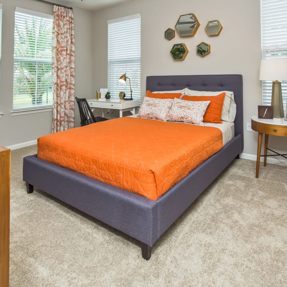 Bedroom with plush carpeting at Audubon Park Apartments in Orlando, Florida
