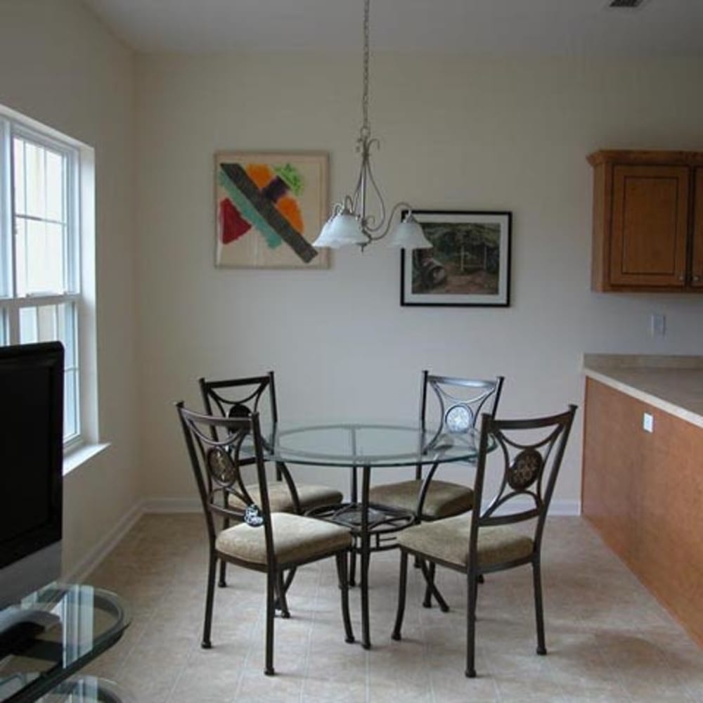 A glass dining table and chairs in an apartment at Mod Villas in Kingsland, Georgia