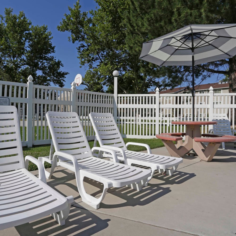 Lounge chairs beside the swimming pool at Mark Twain Apartments in Salt Lake City, Utah