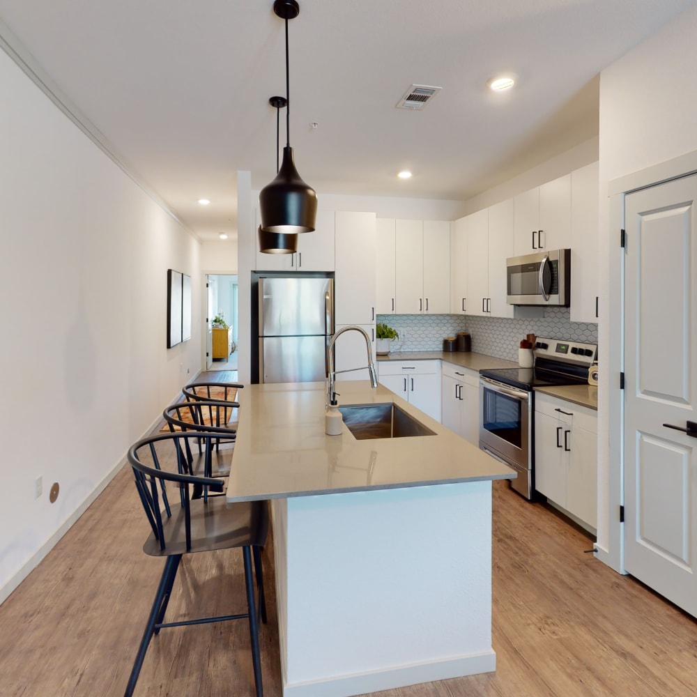 Model apartment with wood-style flooring at The Prospector Modern Apartments in Castle Rock, Colorado