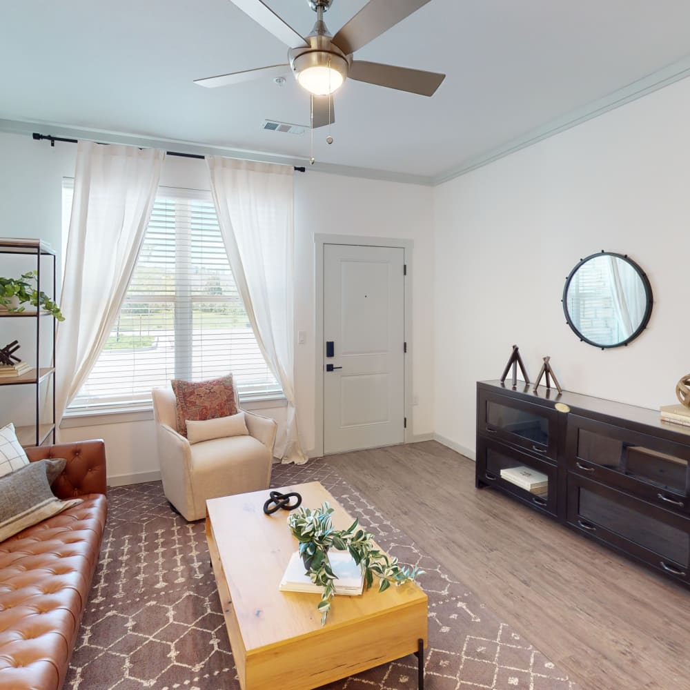 Model living room with a rug at The Prospector Modern Apartments in Castle Rock, Colorado