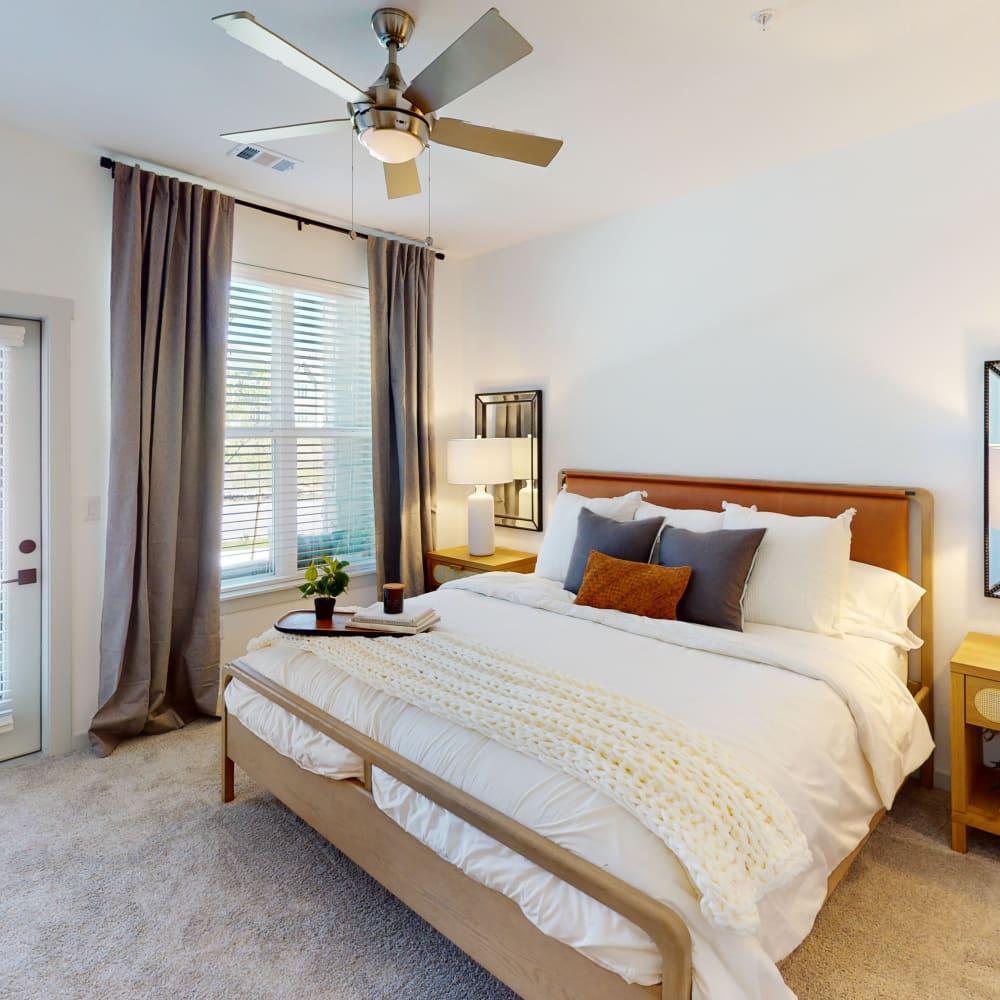 Bedroom with a ceiling fan at The Prospector Modern Apartments in Castle Rock, Colorado