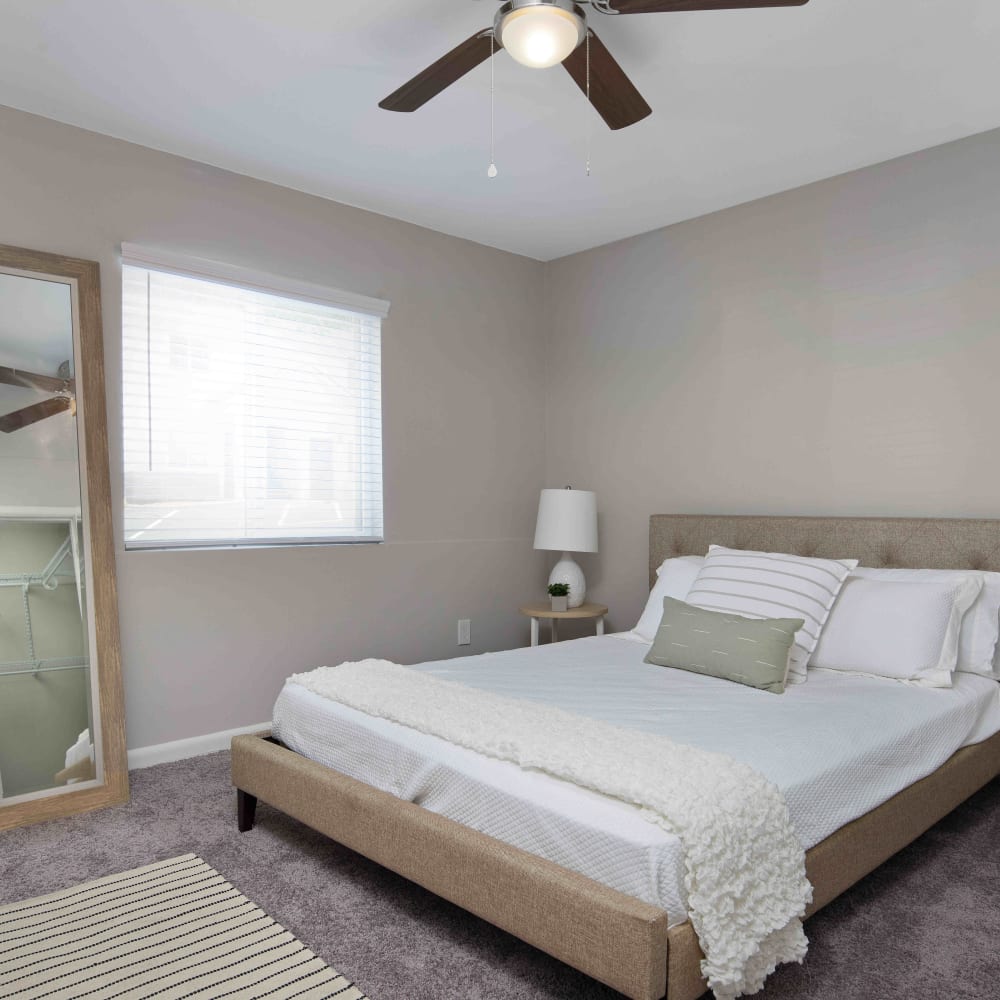 Model bedroom with white bedding at Oak Pointe in Atlanta, Georgia