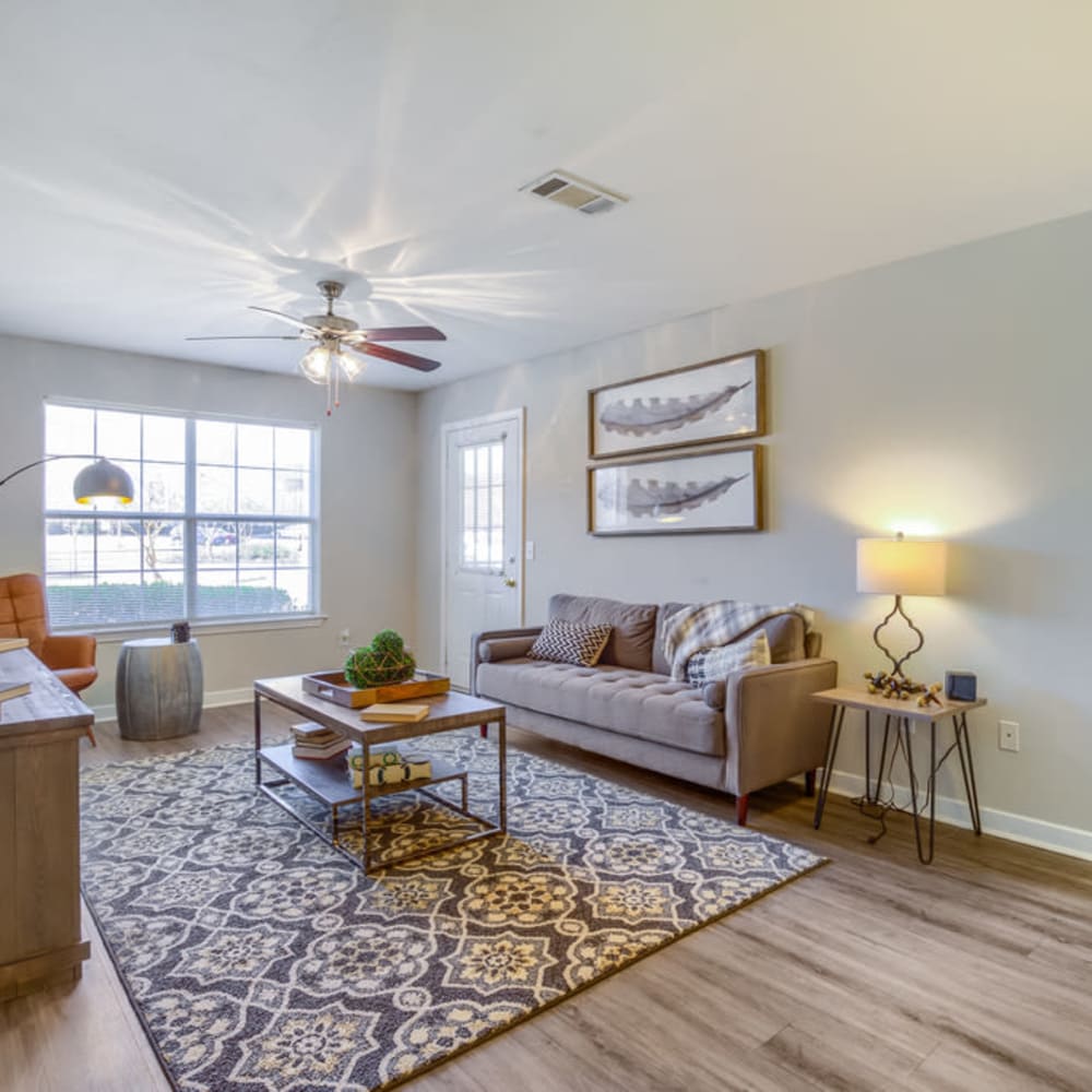 A furnished apartment living room with a door to the balcony at Spring Lake in Byram, Mississippi