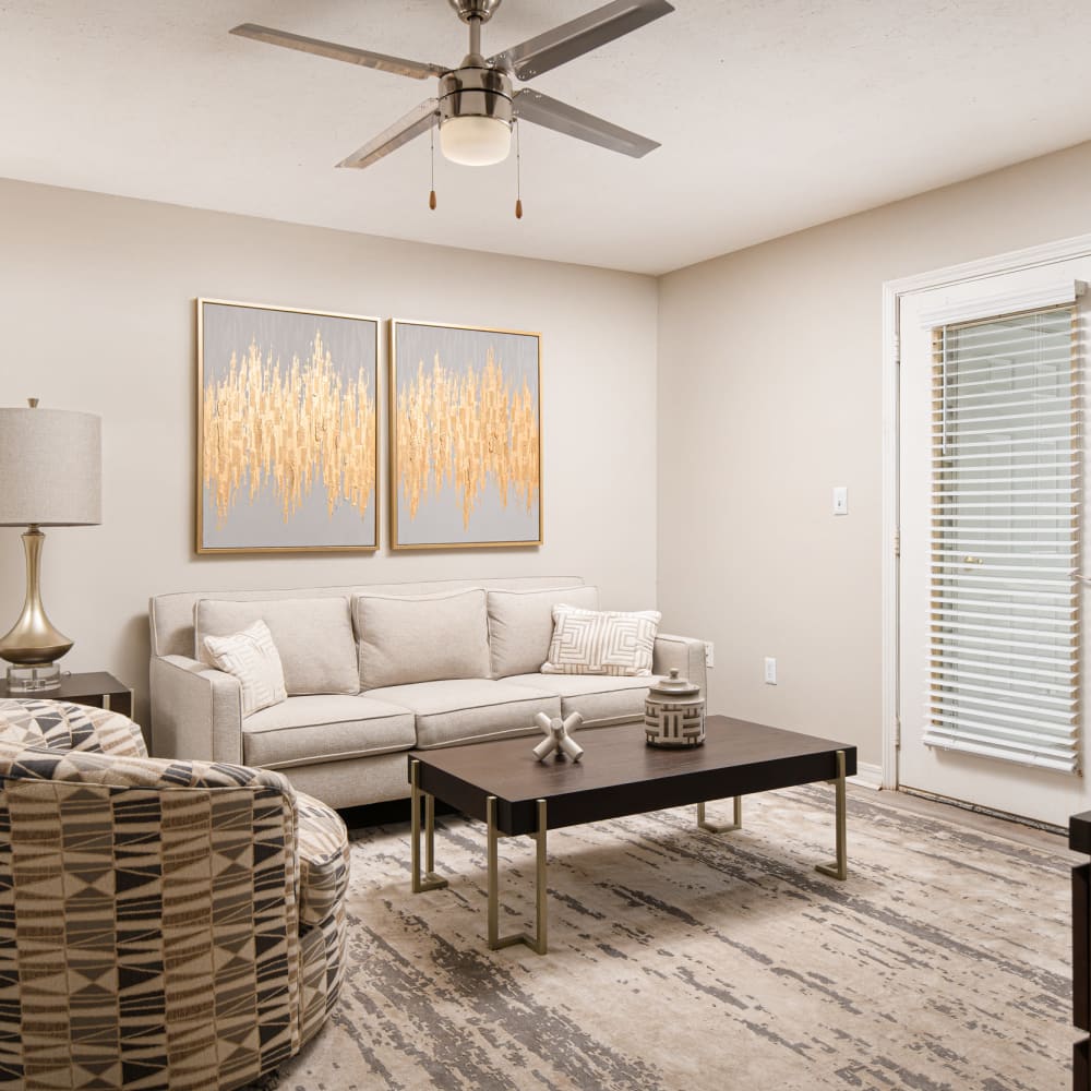 A furnished apartment living room with a door to the balcony at Midsouth 301 in Jackson, Mississippi