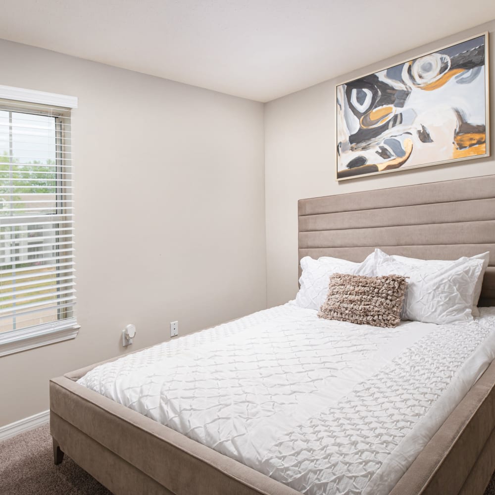 A furnished model bedroom with a window at Midsouth 301 in Jackson, Mississippi
