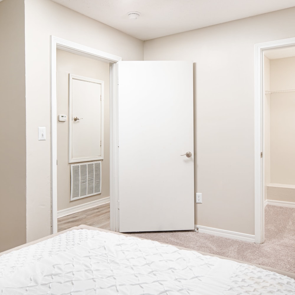 An apartment bedroom with the door open at Midsouth 301 in Jackson, Mississippi