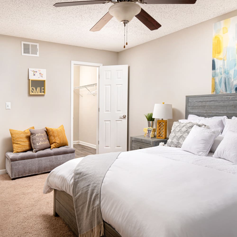 A furnished bedroom with a ceiling fan at Northbrook & Pinebrook in Ridgeland, Mississippi