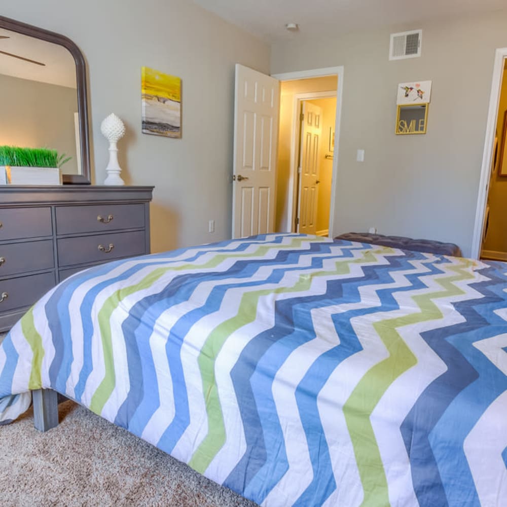 A furnished bedroom with an attached bathroom at Northbrook & Pinebrook in Ridgeland, Mississippi