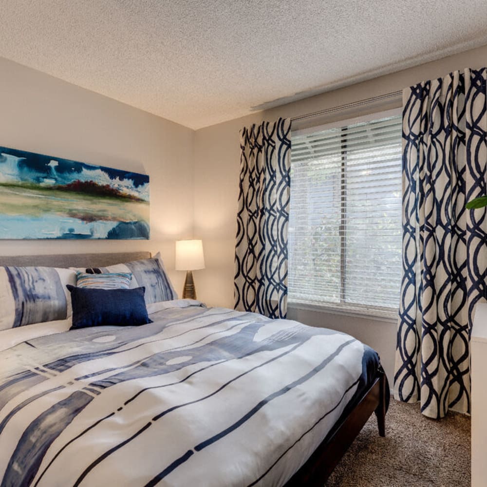 Bedroom with large windows at The Commons in Federal Way, Washington