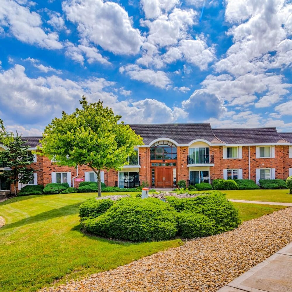 Exterior of an apartment building and surrounding landscape at Huntington Apartments in Naperville, Illinois