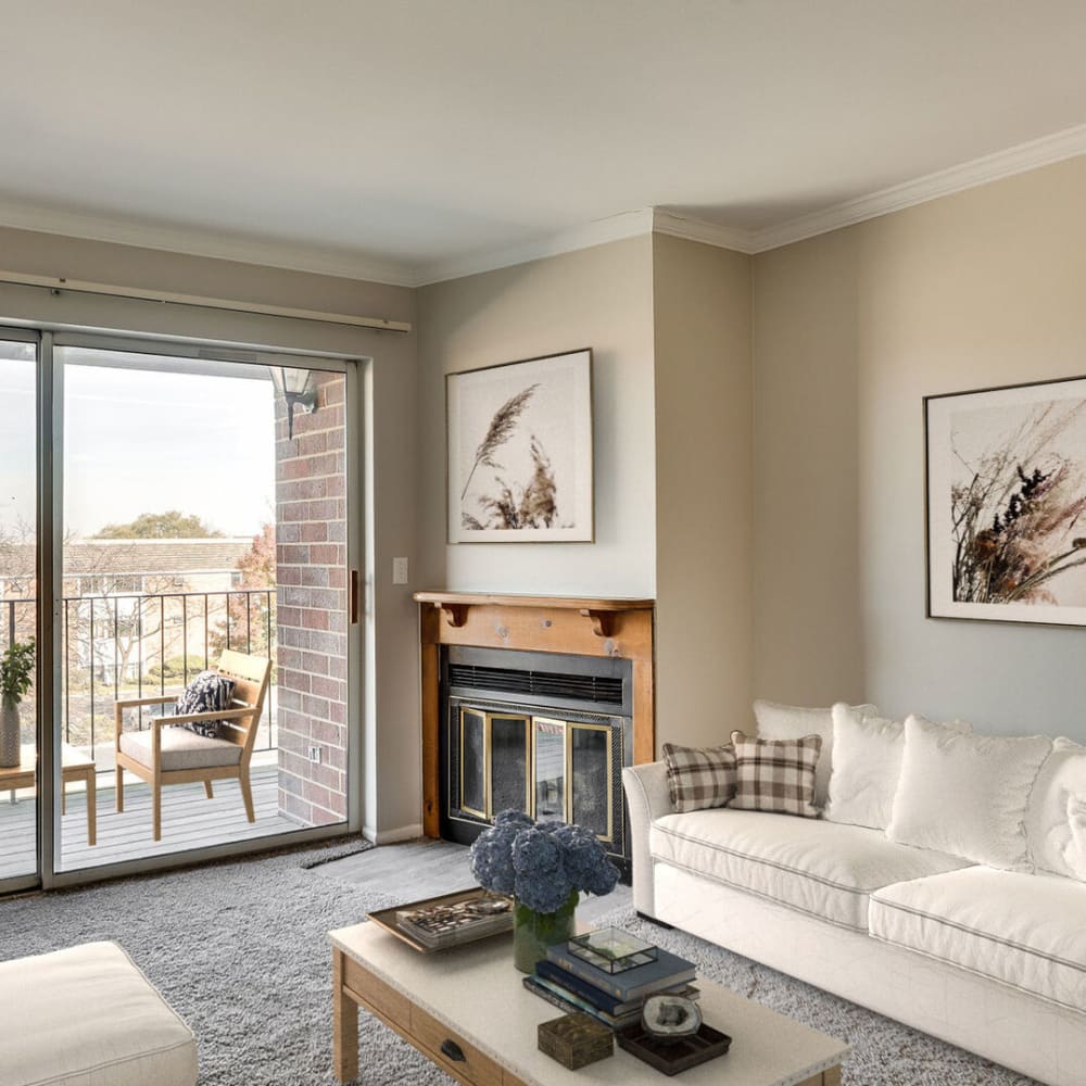 A furnished apartment living room with a fireplace at Huntington Apartments in Naperville, Illinois