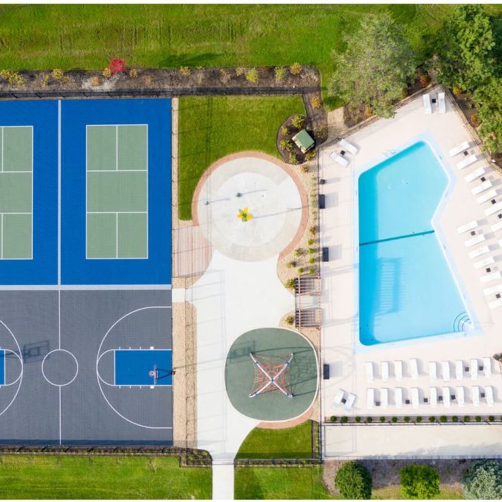 An aerial view of the swimming pool and sports courts at Huntington Apartments in Naperville, Illinois