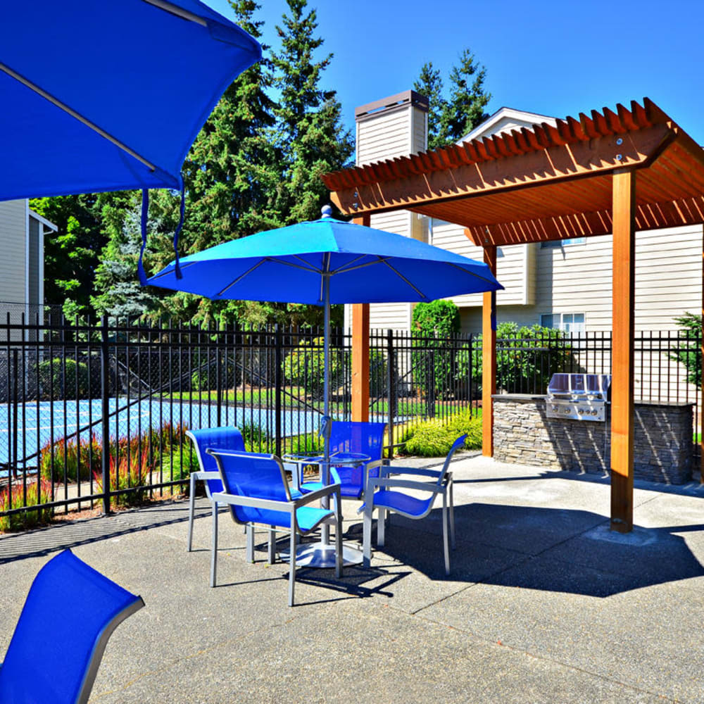 Patio table and chairs with umbrellas at The Windsor in Renton, Washington