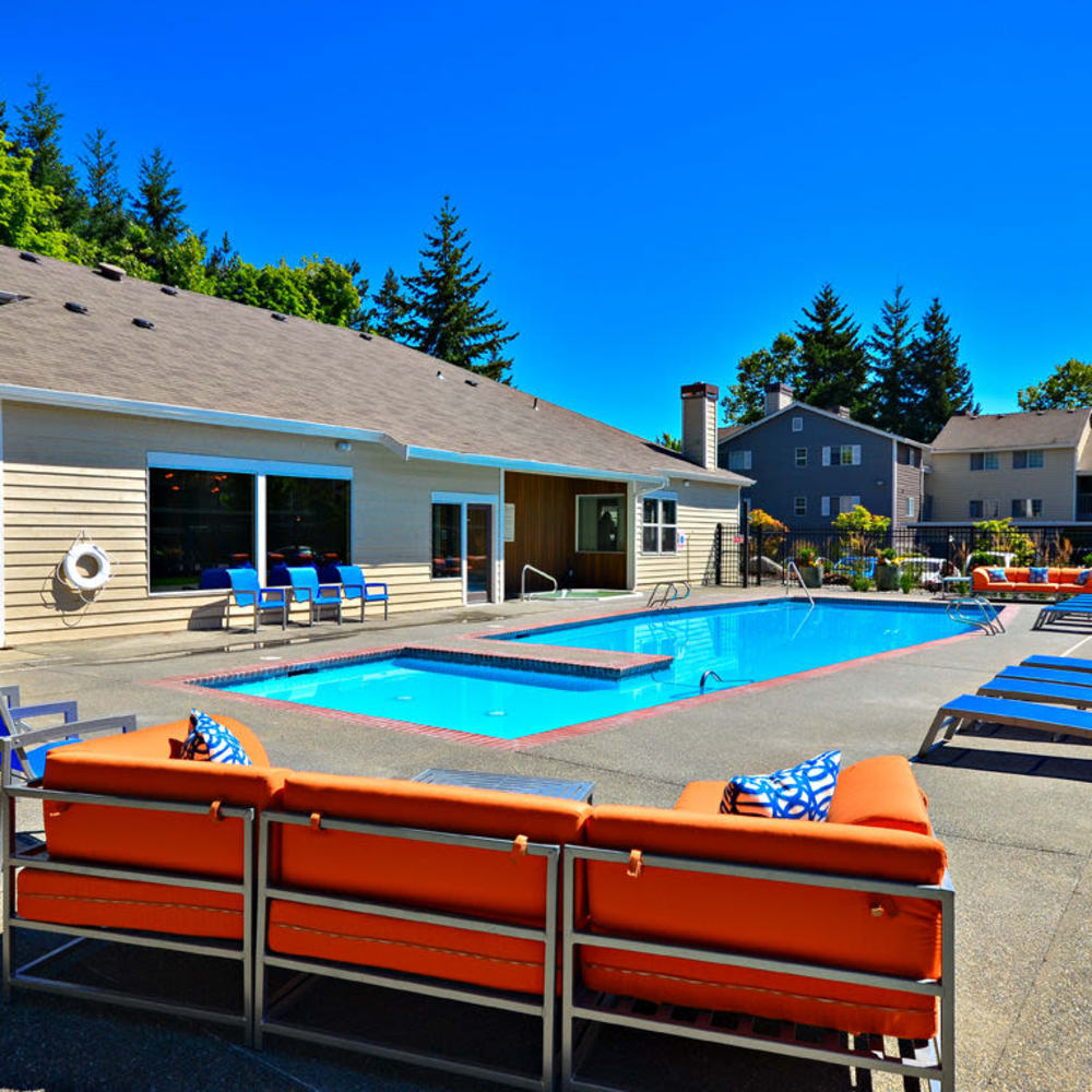 Swimming pool with lounge pool side seating at The Windsor in Renton, Washington