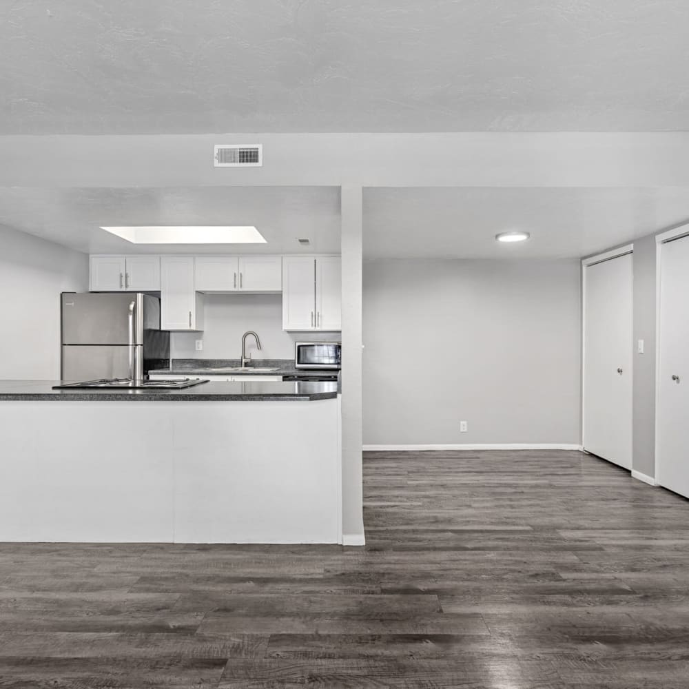 Living space with dark plank flooring at Windgate at Bountiful in West Bountiful, Utah