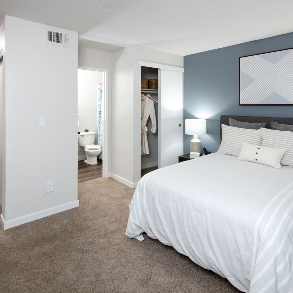 Model bedroom with blue accents at The Hayden in Martinez, California