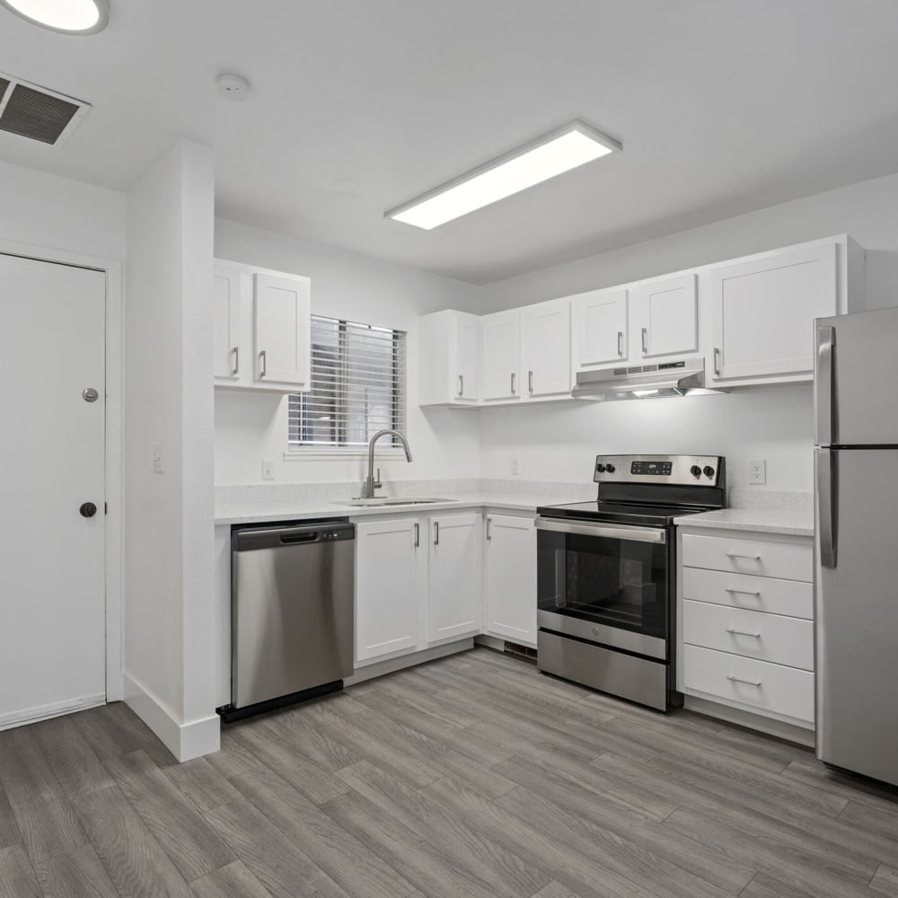 Model kitchen with black appliances at The Franklyn Apartments in Millcreek, Utah