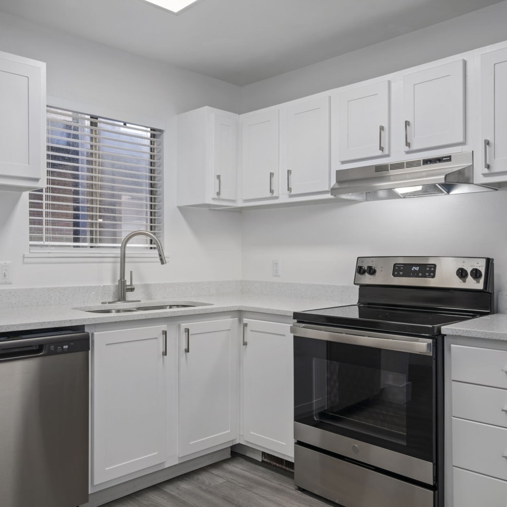 Model kitchen with white cabinets at The Franklyn Apartments in Millcreek, Utah