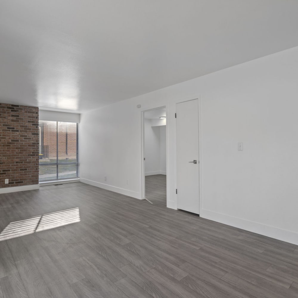 Model living space with brick wall at The Franklyn Apartments in Millcreek, Utah