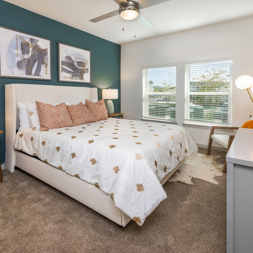 Cozy and carpeted bedroom in a model home at Novo Kendall Town in Jacksonville, Florida