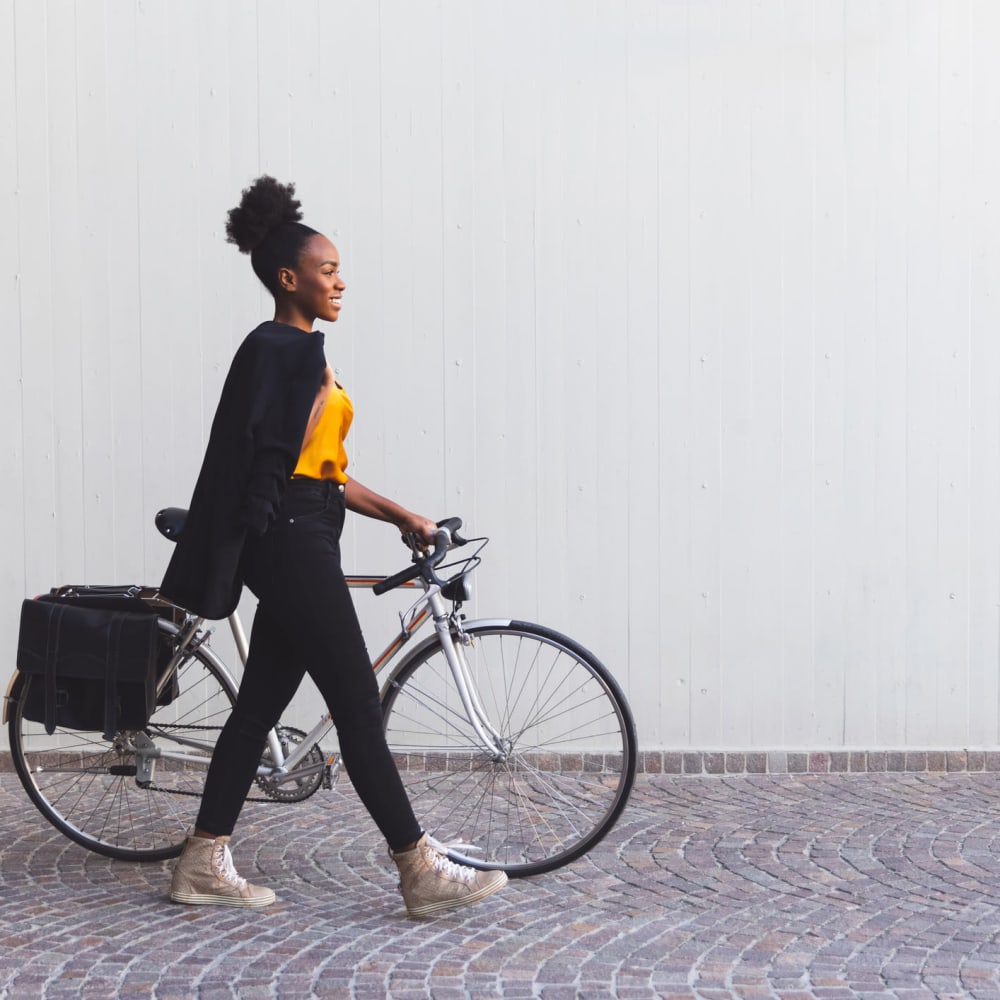 Woman walking her bike at  Lyford Apartments in Tiburon, California
