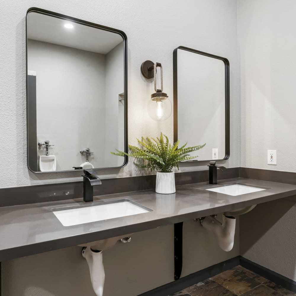 Clubhouse bathrooms with large mirrors at Apex at Sky Valley in Reno, Nevada