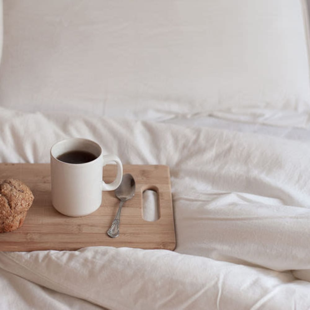 Image of a coffee cup on a cutting board in a bed at Canyon Village in North Hollywood, California