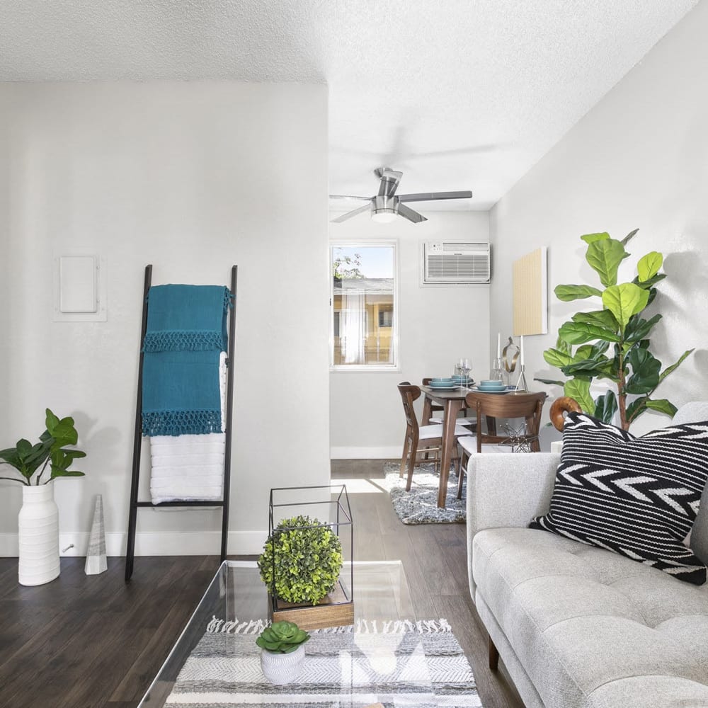 Living space with a couch and coffee table at Casitas Apartments in Ontario, California