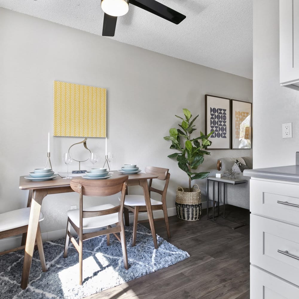 Dinning space featuring a table and chairs at Casitas Apartments in Ontario, California