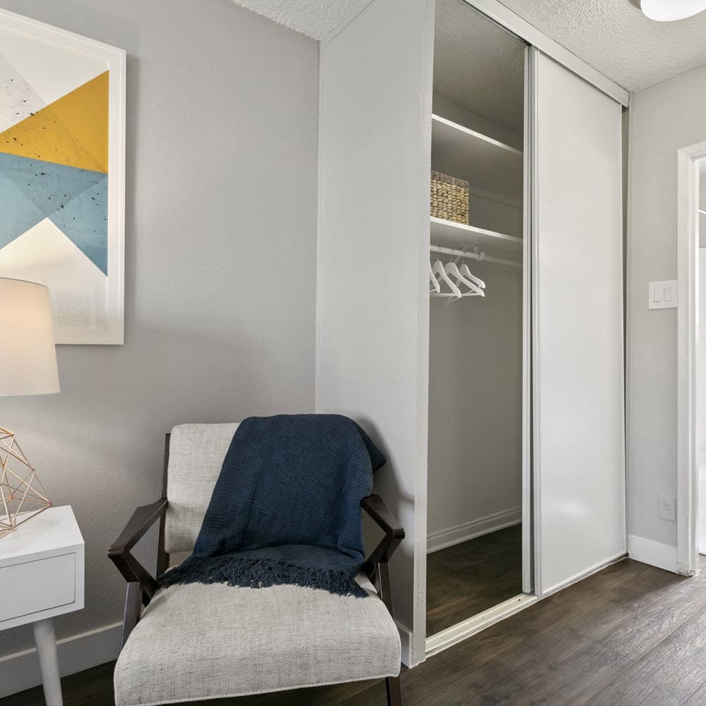 Bedroom with sliding door closets at Casitas Apartments in Ontario, California