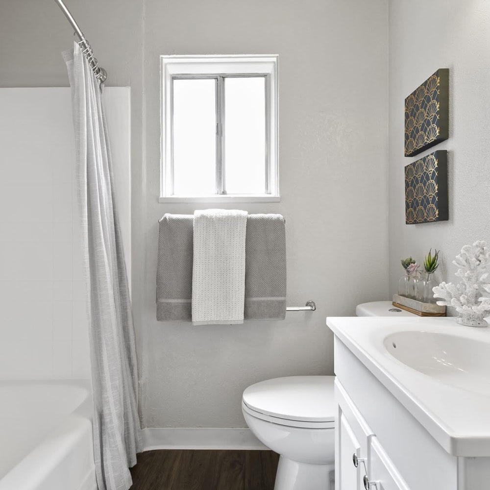 Resident bathroom with great lighting at Casitas Apartments in Ontario, California