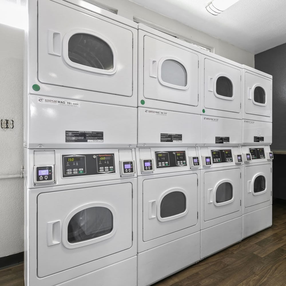 Stacked multiple dryers in laundry facility at Casitas Apartments in Ontario, California