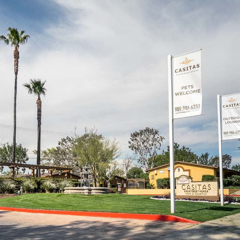 Be greeted by flags and landmarks approaching Casitas Apartments in Ontario, California