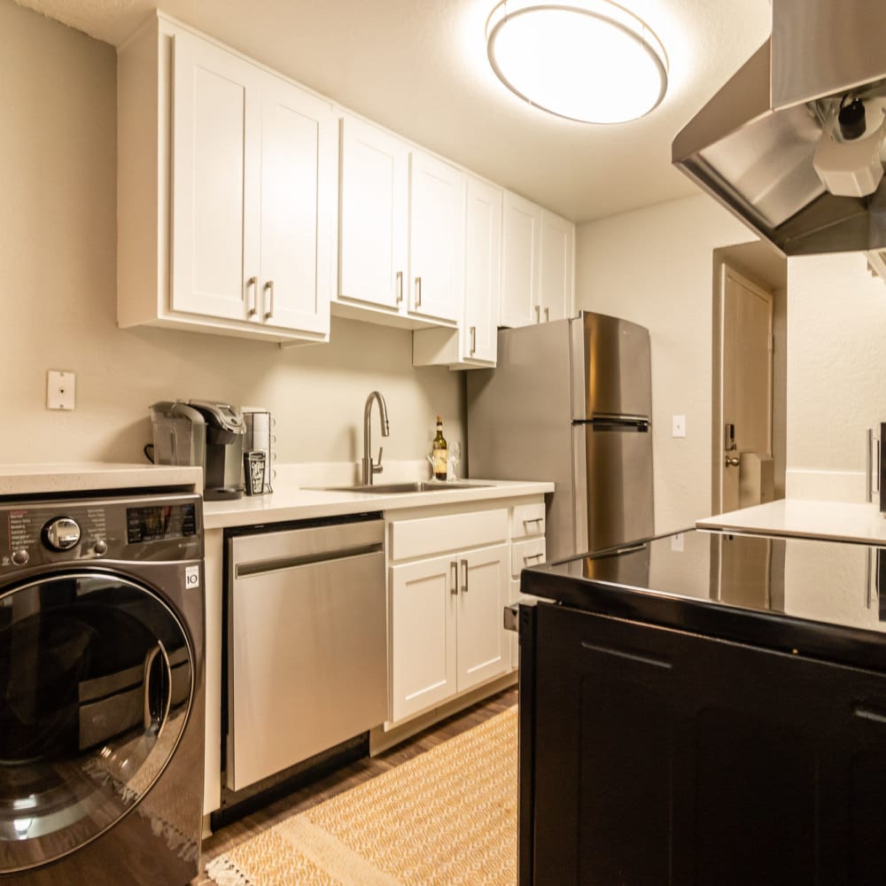  Apartments in in Reno, Nevada  for Rent - The Element Apartments - Modern Kitchen with White Cabinets, Stainless Steel Appliances, and White Countertops