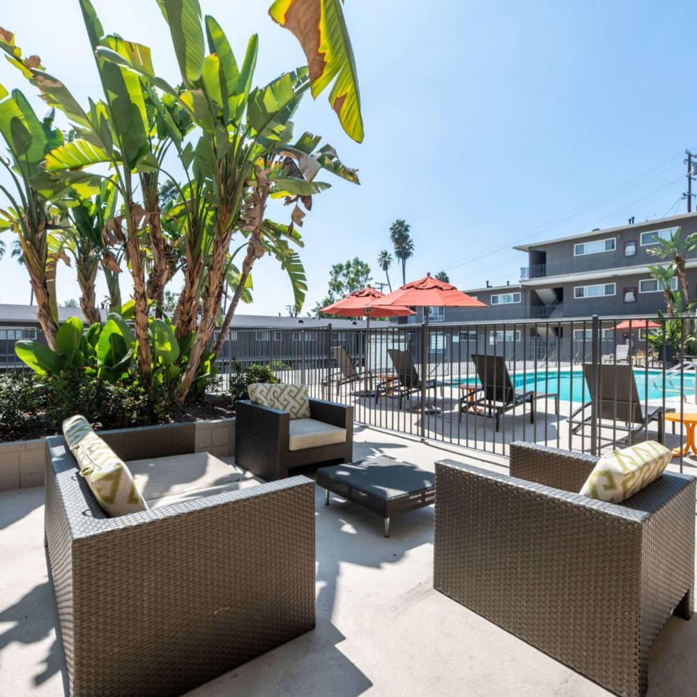 Patio furniture featuring couches and chairs pool side at Emerald Hills in Monterey Park, California