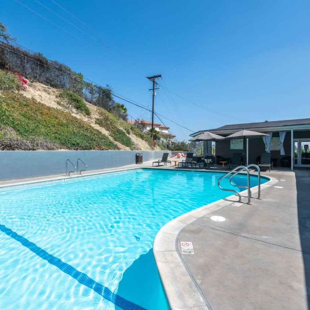 Refreshing swimming pool with pool side seating at Emerald Hills in Monterey Park, California